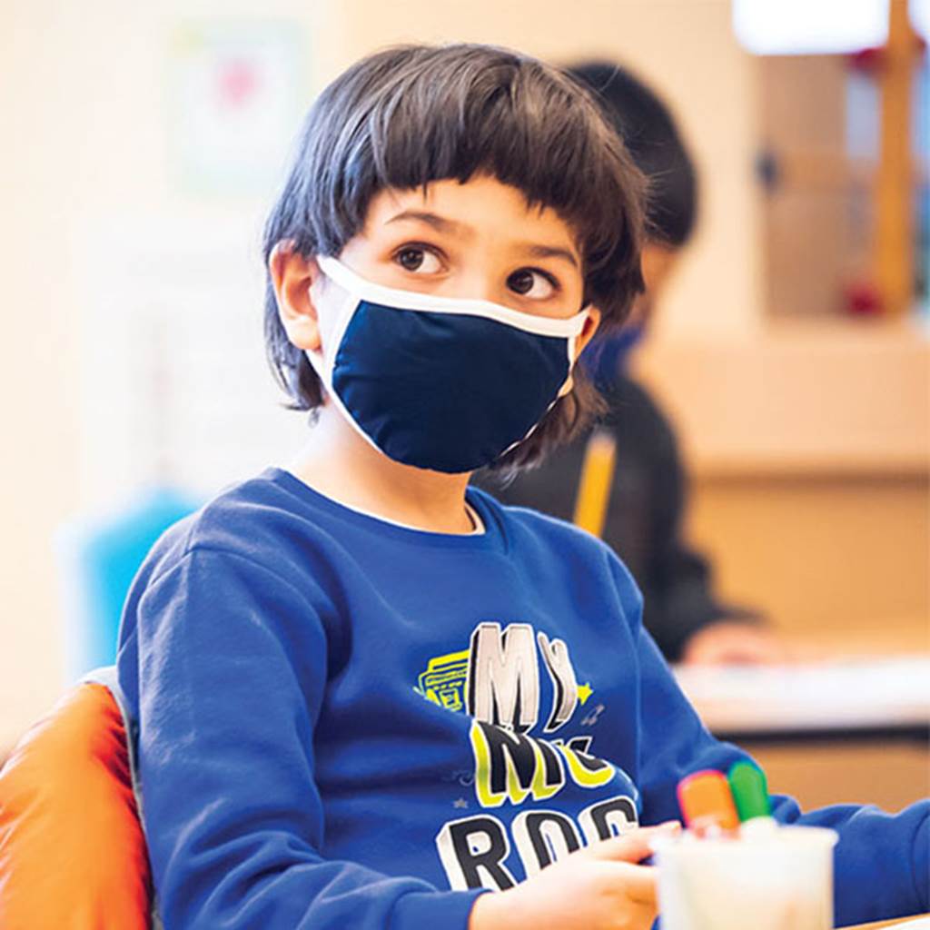 Young student looking at teacher