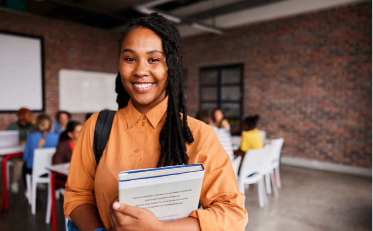 image smiling student holding book