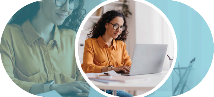 Woman looking at a computer smiling.