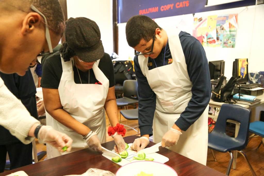 Students cutting vegetables