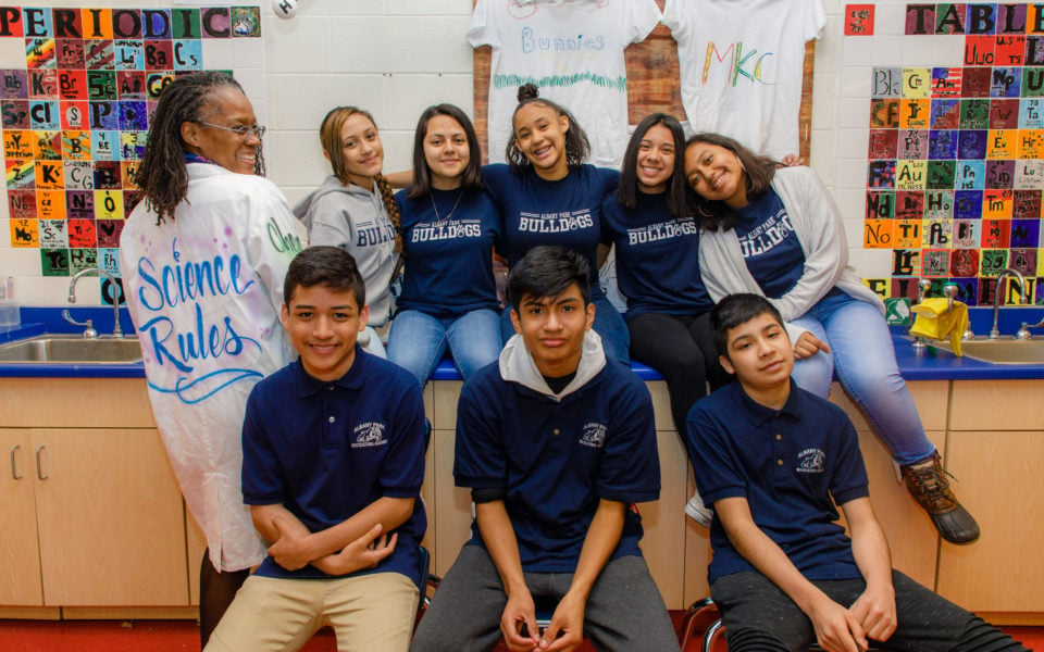 A group of students pose with a teacher