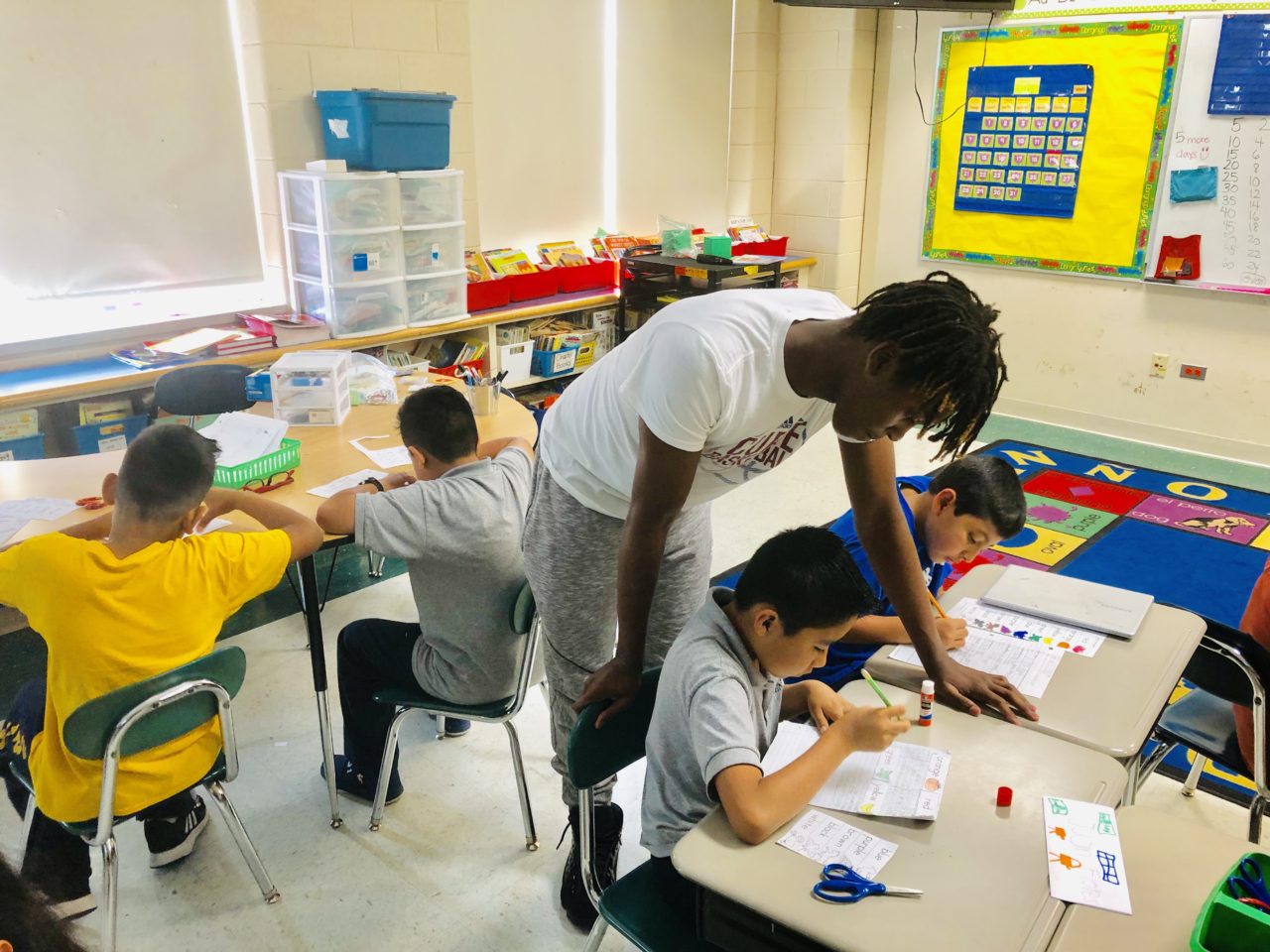 Teacher helps student on classwork