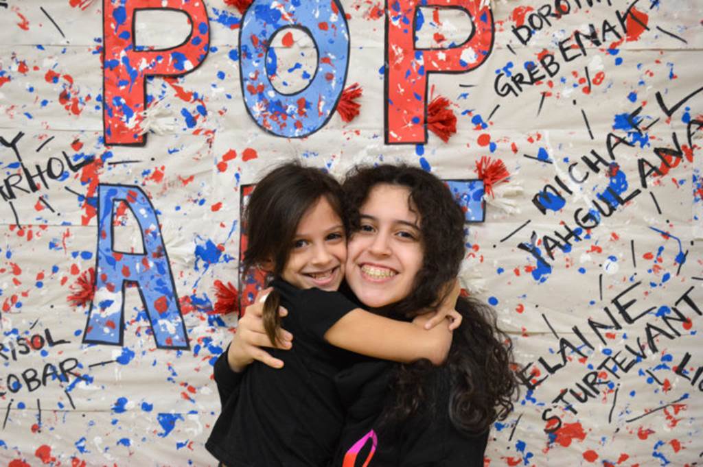 Two girls hug