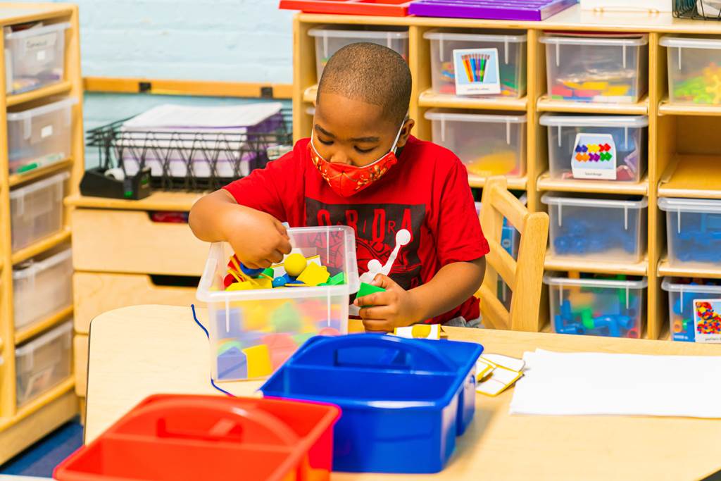 A student playing with legos