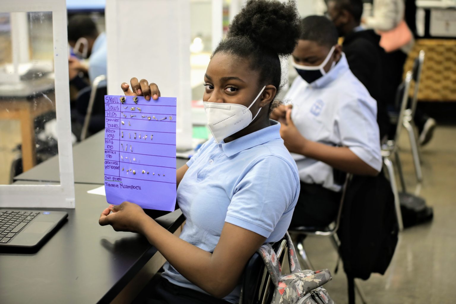 A student holding up a piece of paper