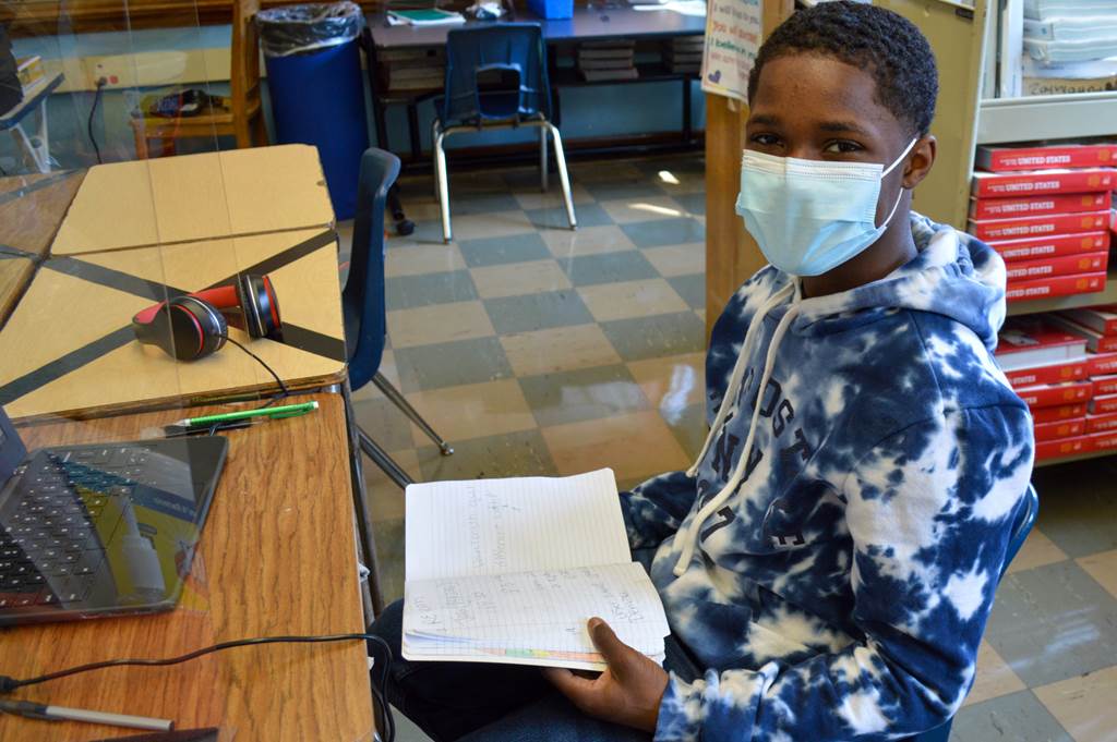 Demari holding a notebook