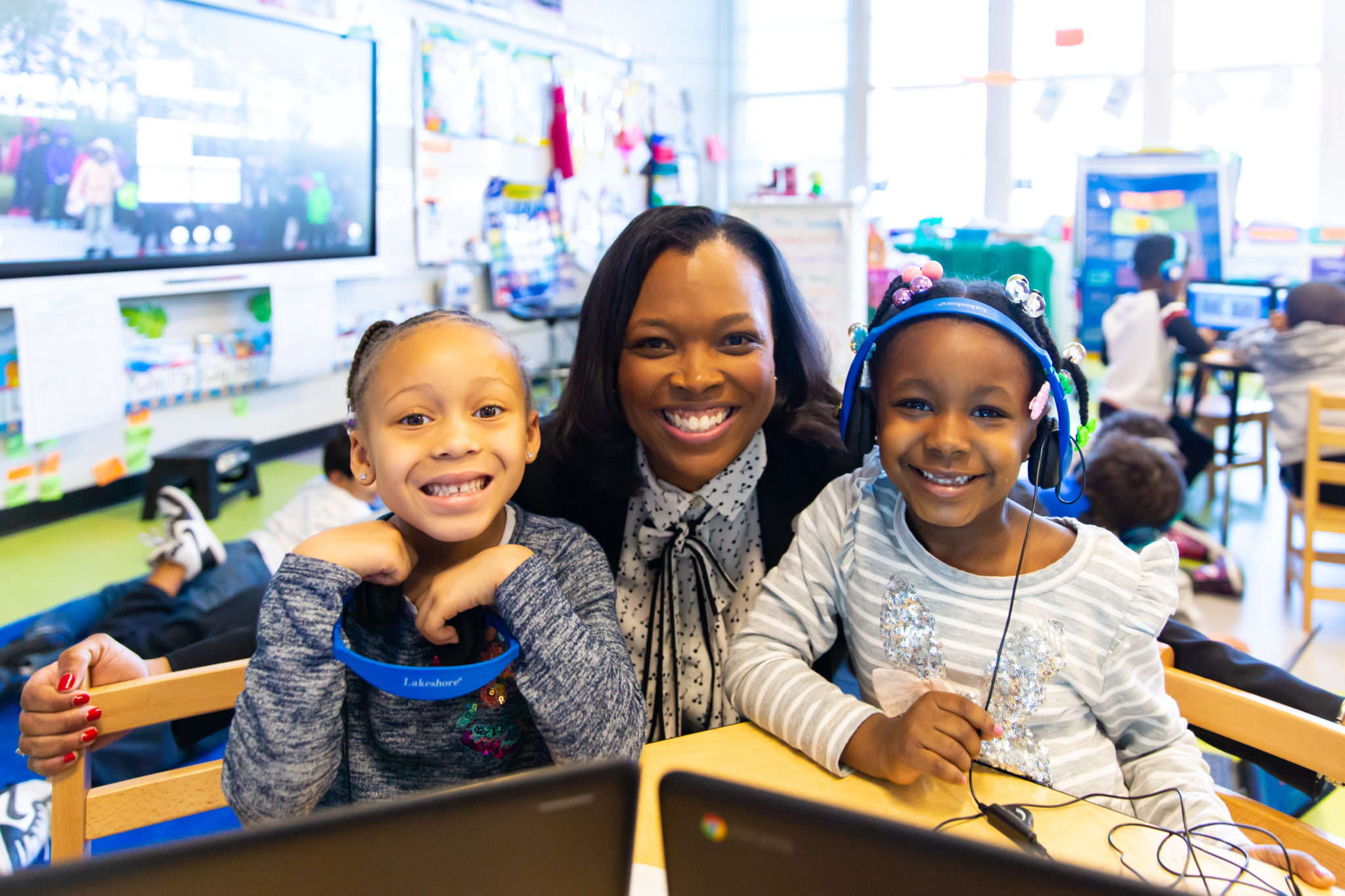 Janice posing with two students