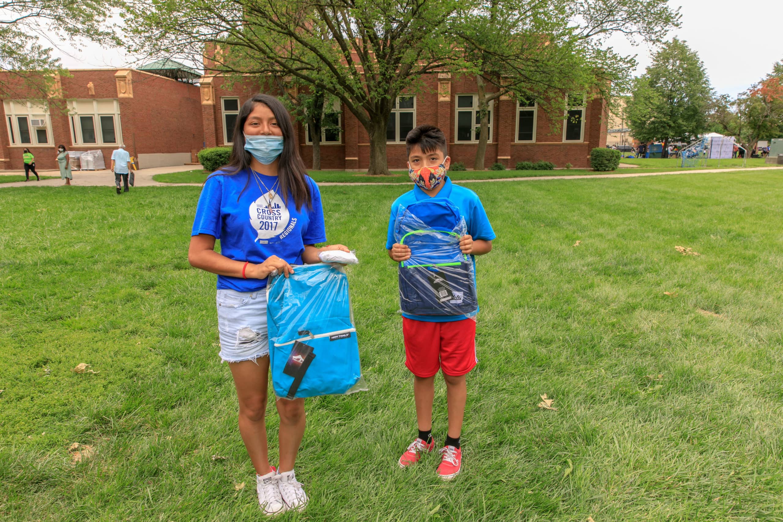 Students holding new backpacks