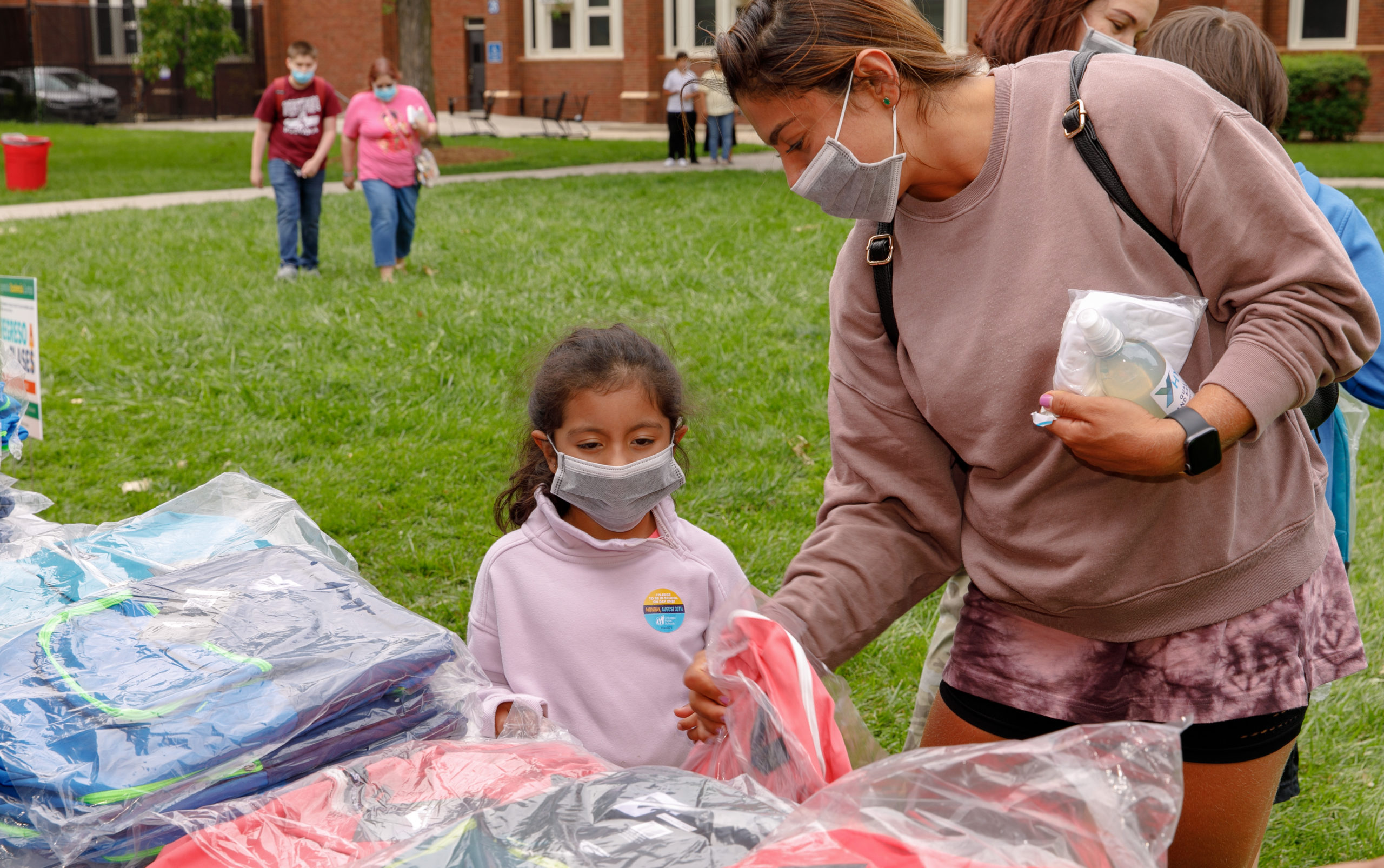 Parent and student receiving backpacks