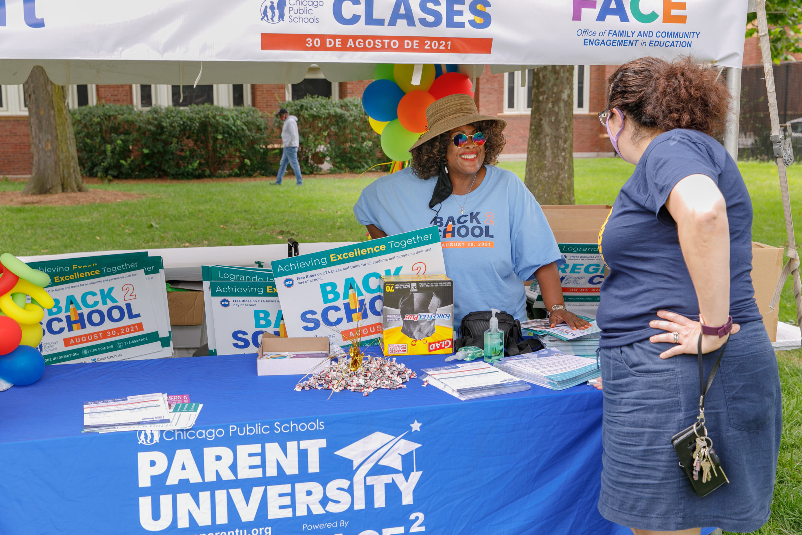 Staff talking to parents at a table
