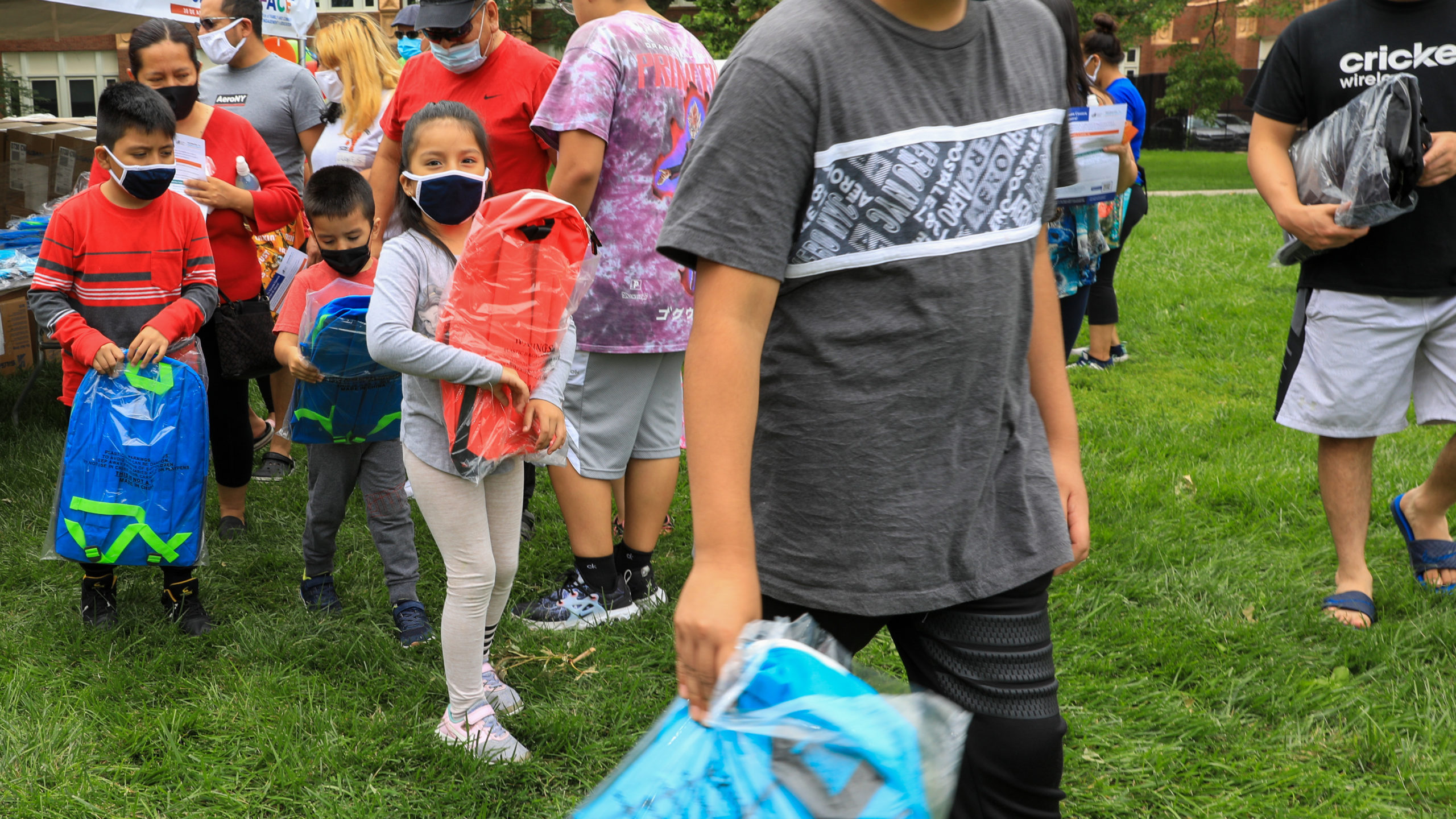 Students holding new backpacks