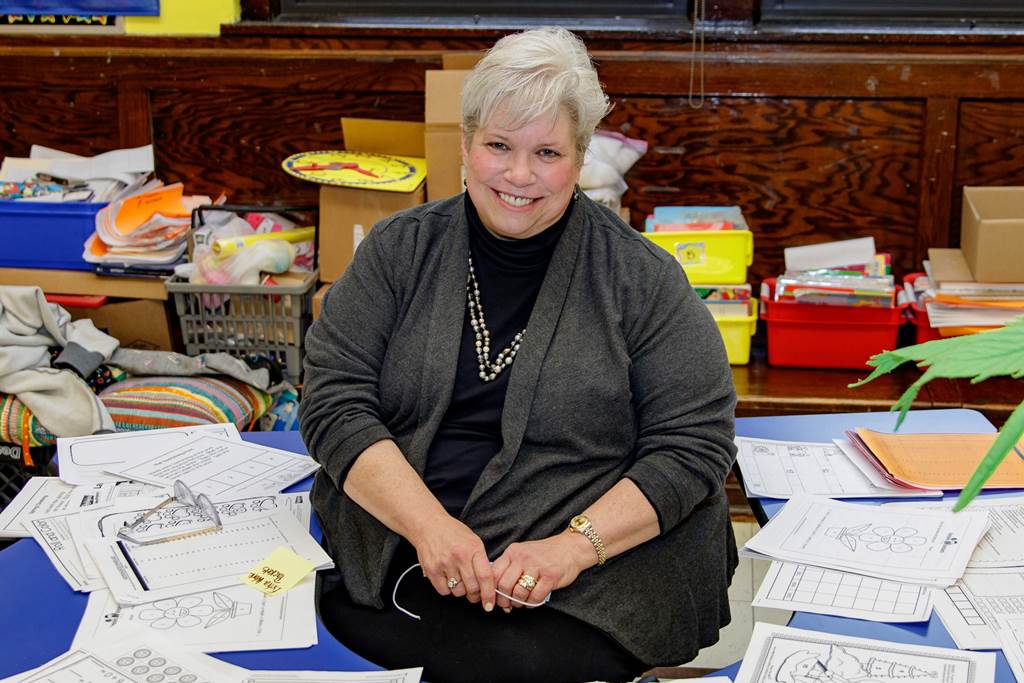Ms. Hall sitting at her desk
