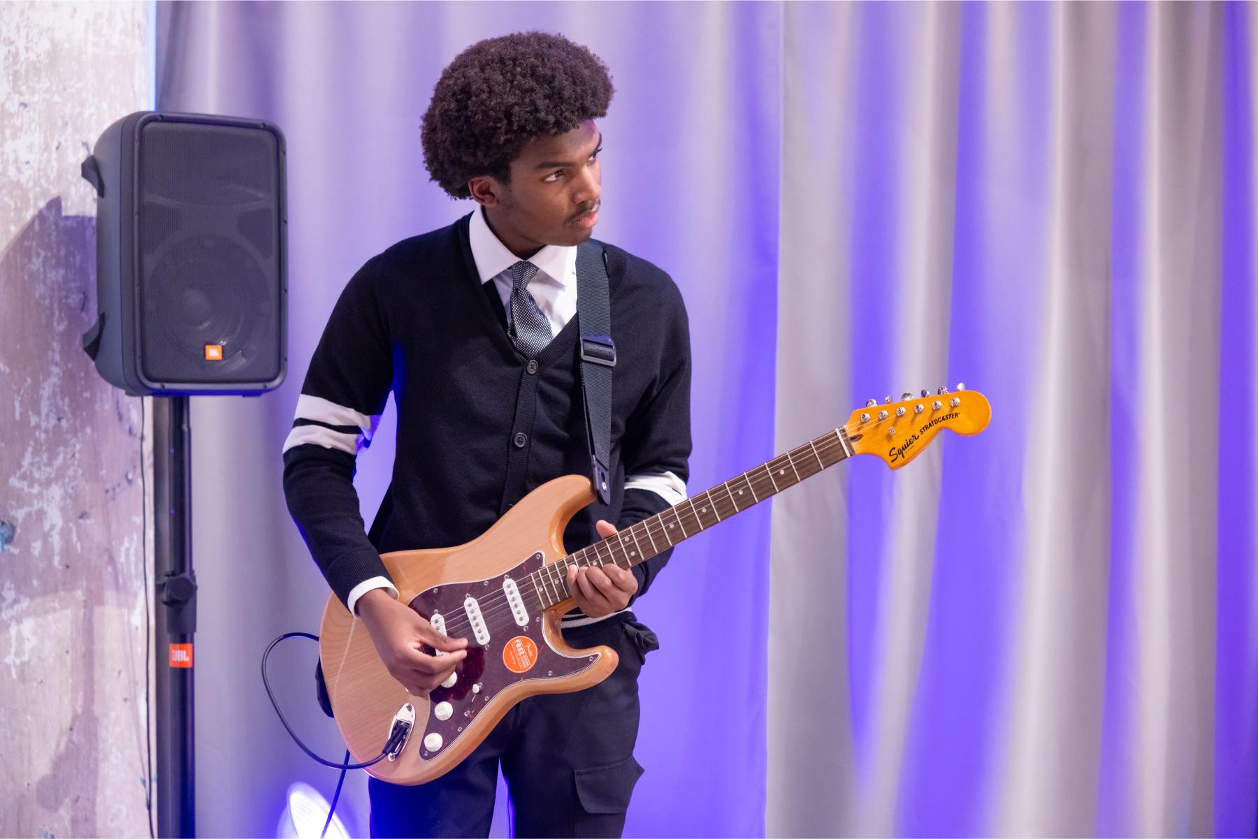 student playing guitar