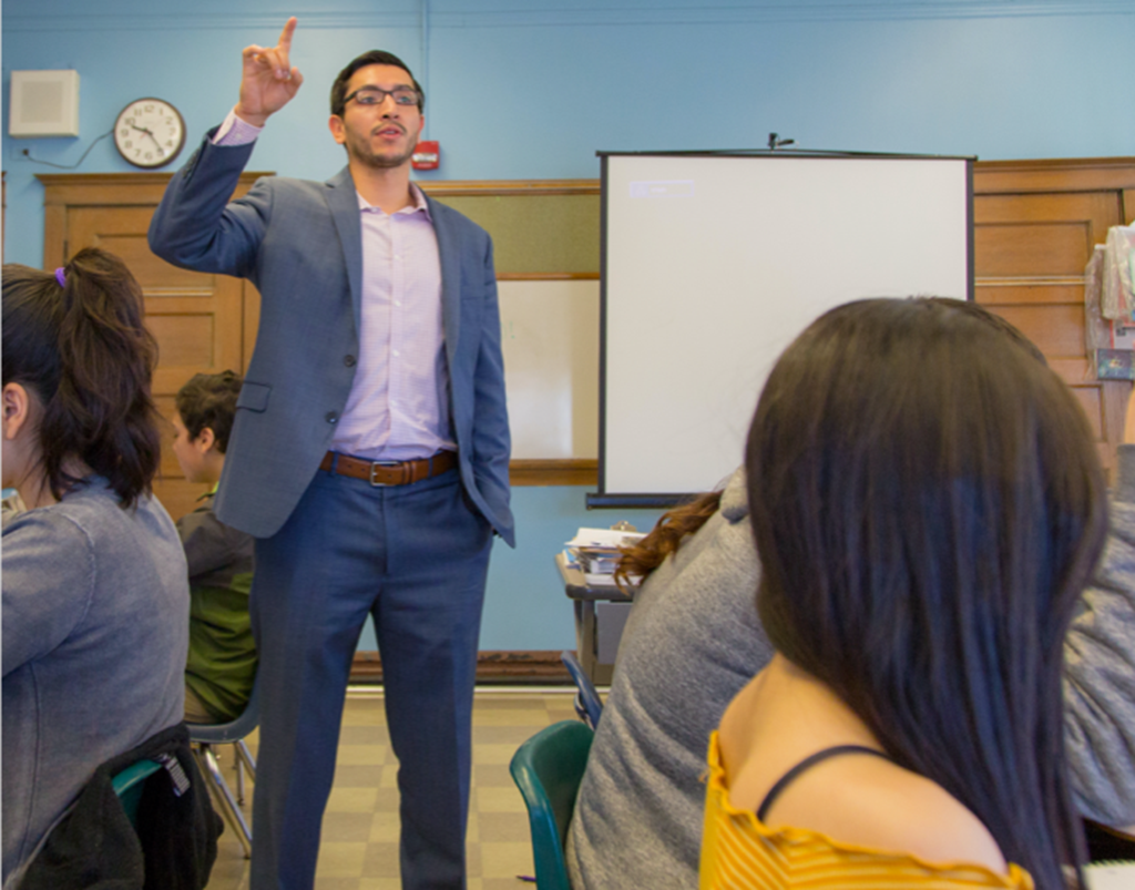 Teacher leading a class full of students