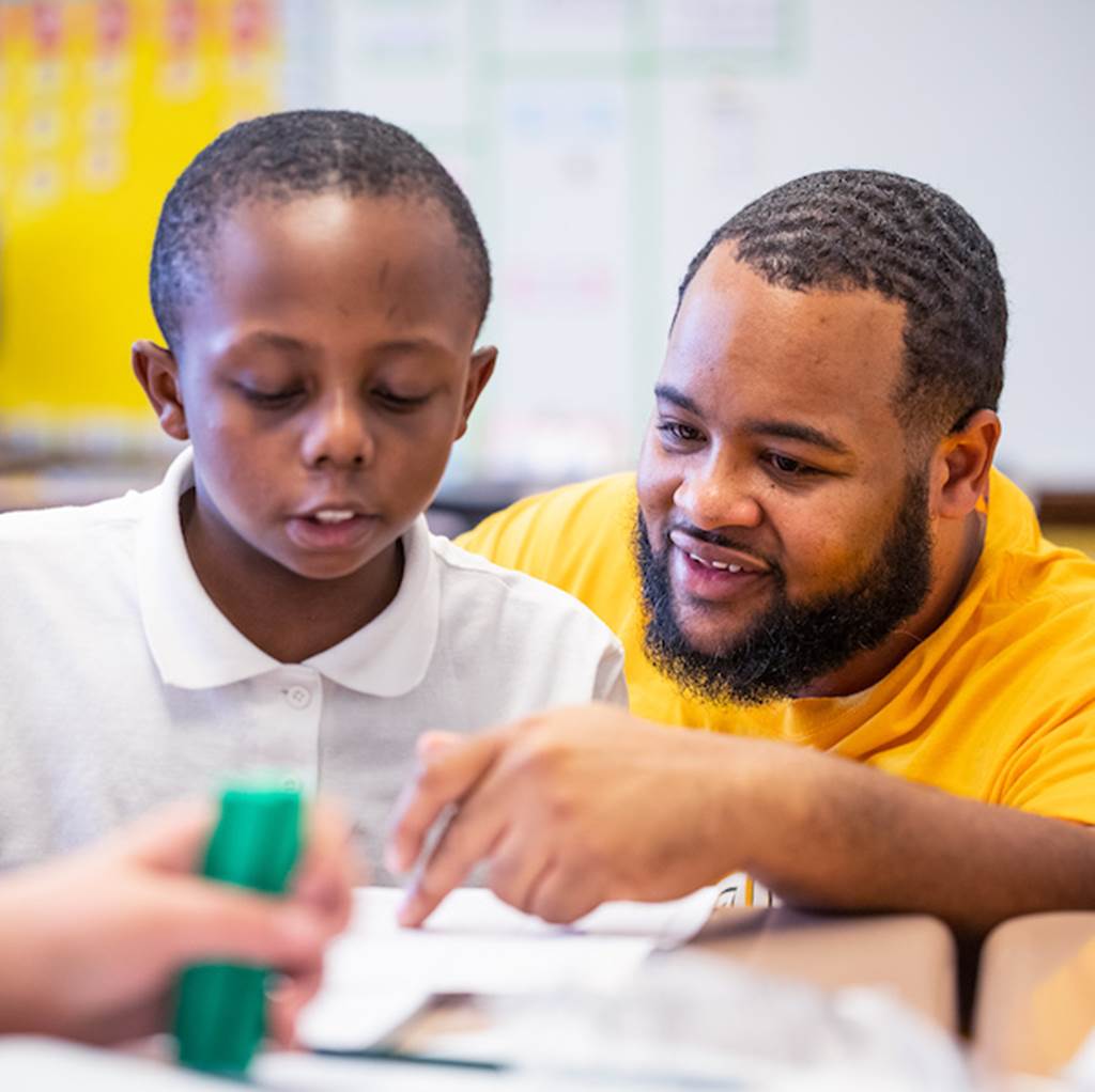 A teacher helps a student